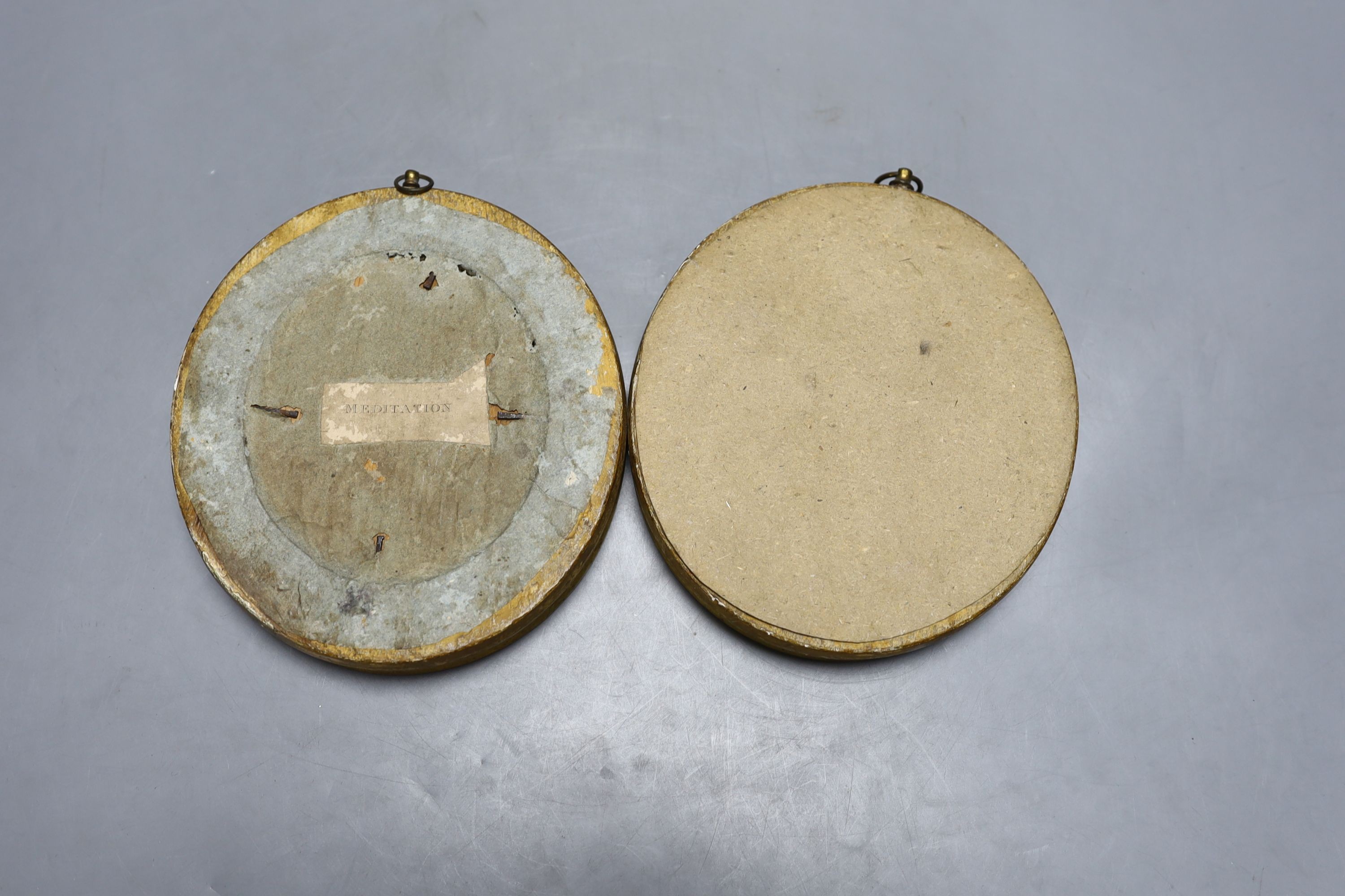 A pair of 19th century oval gilt frames, 6.5cm. high, with inset monochrome prints